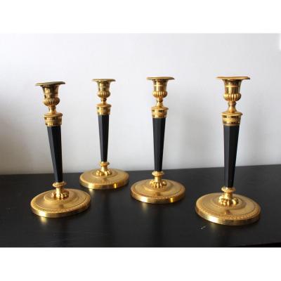 Set Of Four Empire Giltbronze And Patinated Candlesticks