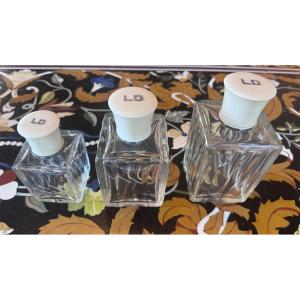 A Set Of Three Perfume Bottles In Crystal, Silver, And Ivory.