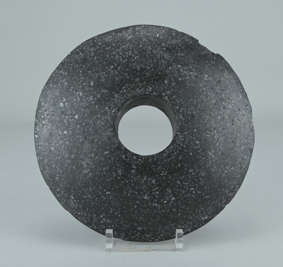 Stone Disc With A Central Hole—possibly A Clubhead From New Guinea