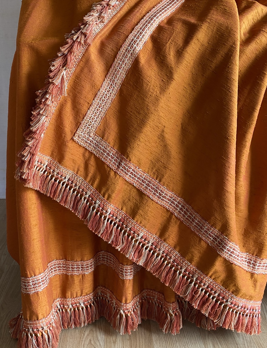 Pair Of Orange Curtains With Raspberry-colored Highlights -photo-1