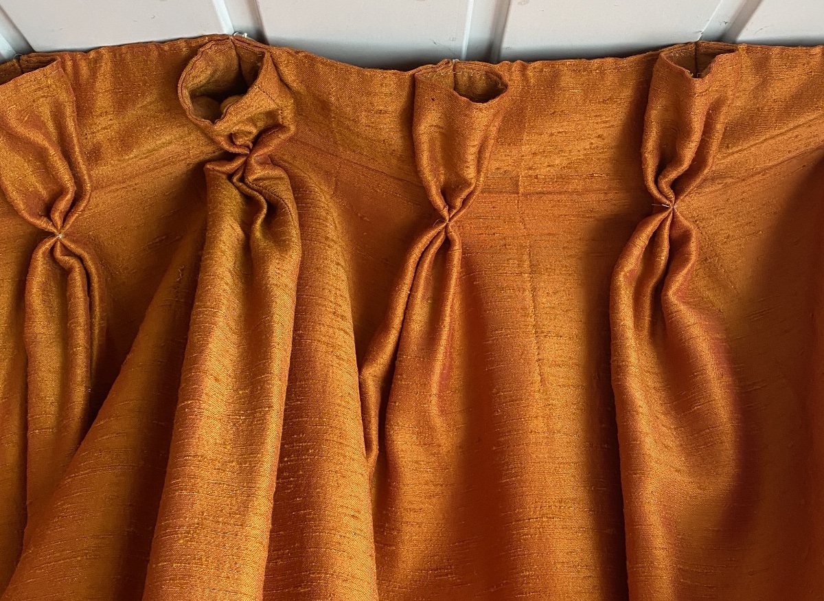 Pair Of Orange Curtains With Raspberry-colored Highlights -photo-3