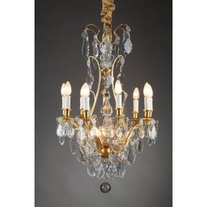 Lustre à huit bras de lumières en bronze doré et pampilles