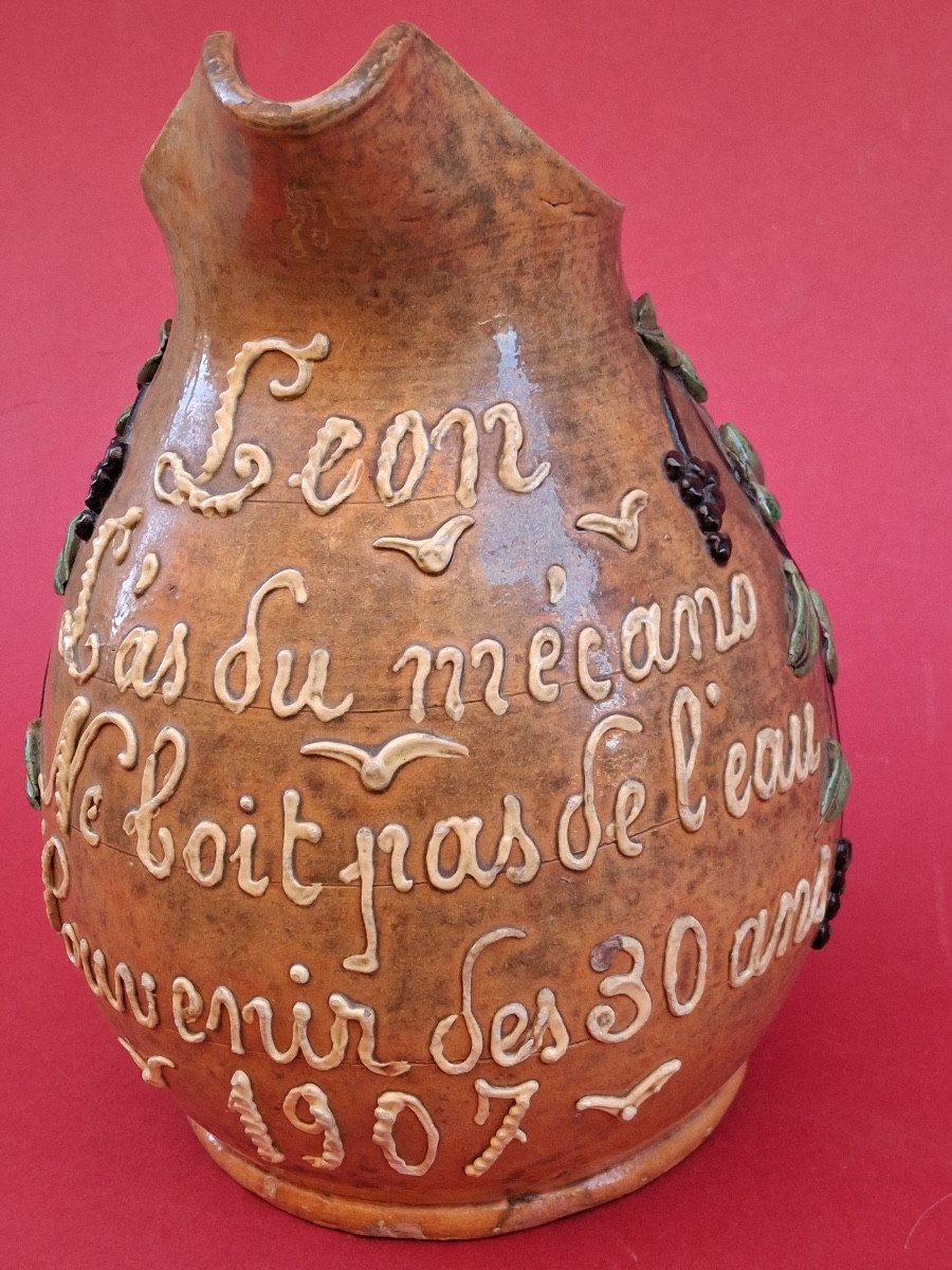 Pichet à vin en terre cuite vernissée  dit " Parlant " datant de 1907 