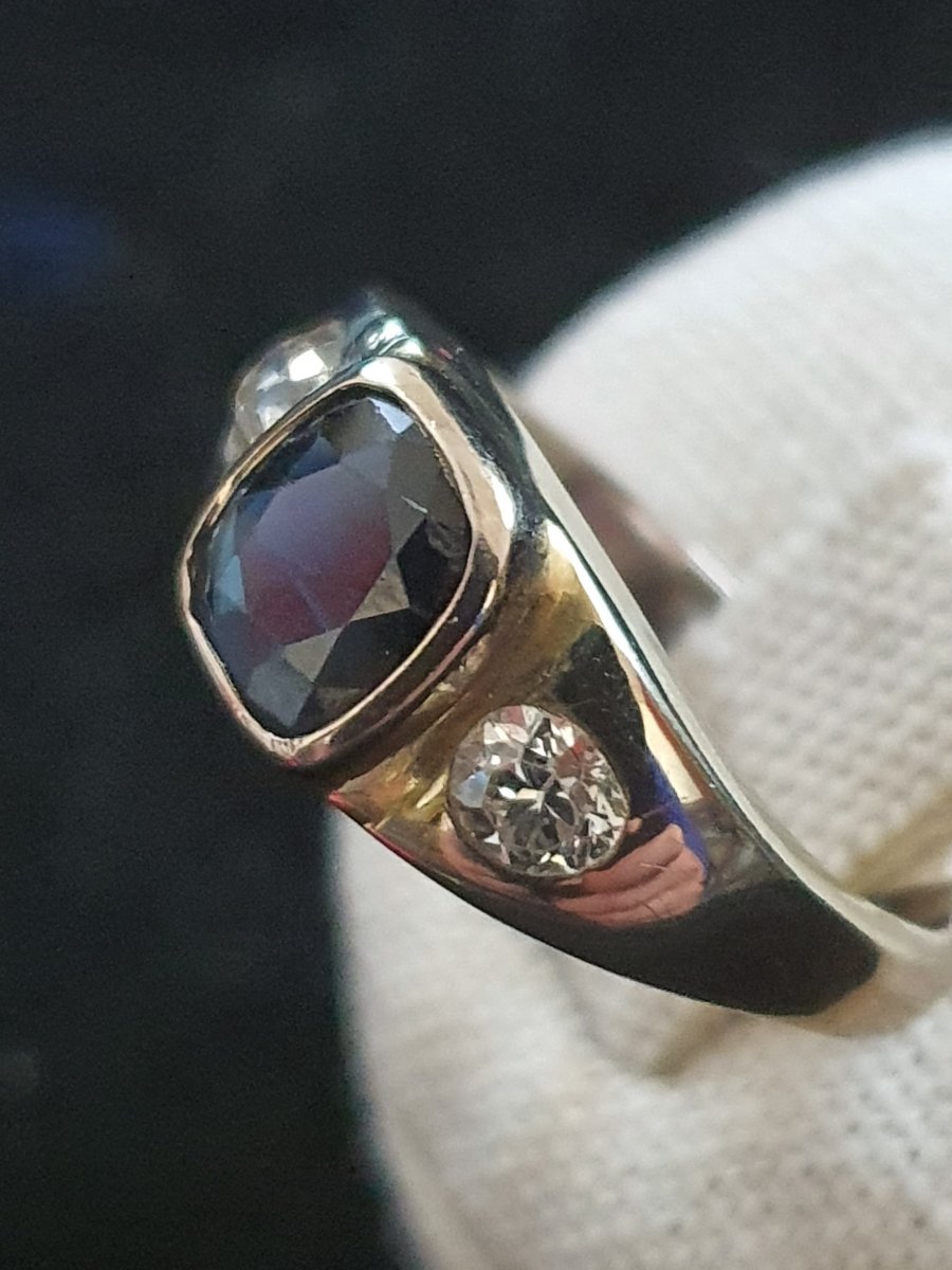 18ct Gold Ring Set With A Sapphire Surrounded By Two Old Cut Diamonds
