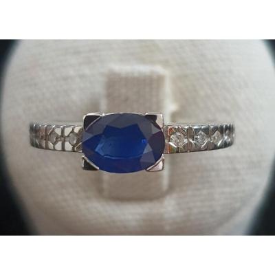 18ct Gold Ring Set With A Sapphire Surrounded By A Paving Of Brilliants