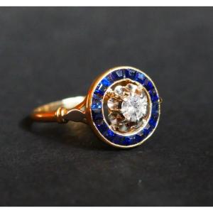 Ring Decorated With A Diamond, Surrounded By Calibrated Sapphires.