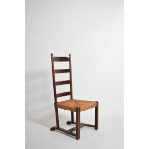 Fauteuil bas en bois et paille, années 1950.