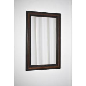 Miroir en bois ébénisé sculpté, à décor de faux écaille de tortue en trompe-l’œil, XIXe siècle.