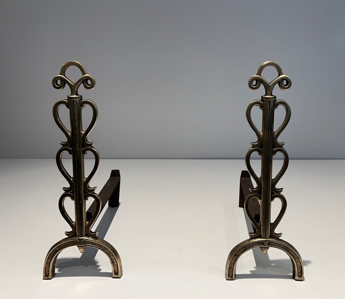 Pair Of Brass And Wrought Iron Andirons. French Work In The Style Of Raymond Subes 1940.