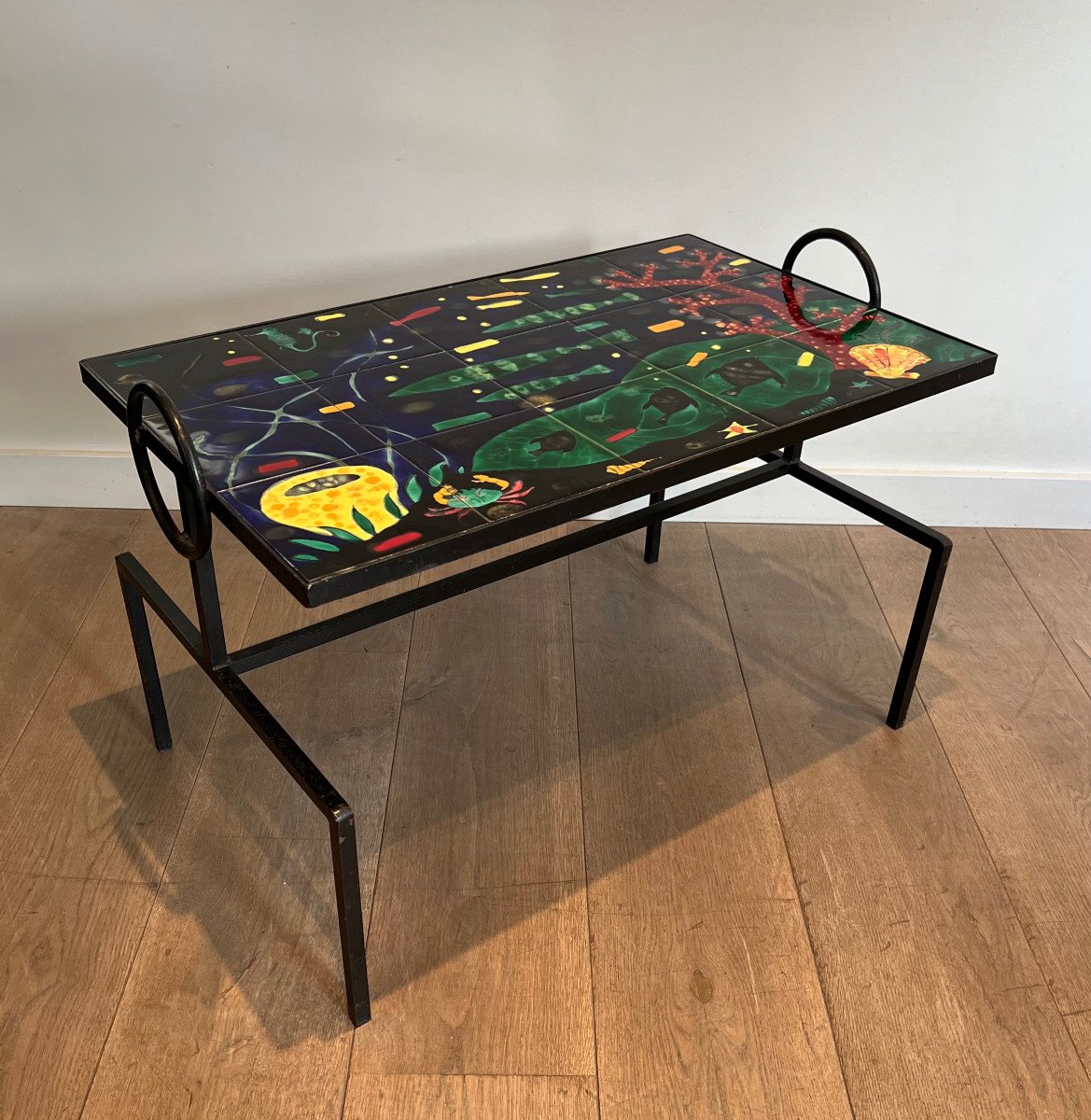 Black Lacquered Metal And Ceramic Coffee Table Decorated With Stylized Fish And Corals. French Work In The Style Of Jacques Adnet. Circa 1950
