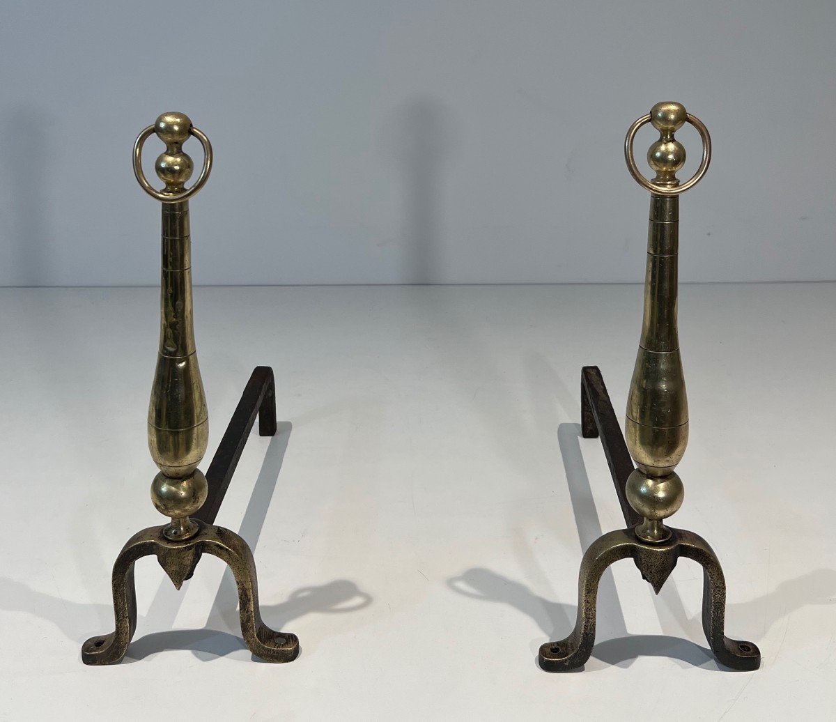 Pair Of Neoclassical Style Andirons In Brass And Wrought Iron. Slight Brass Dents