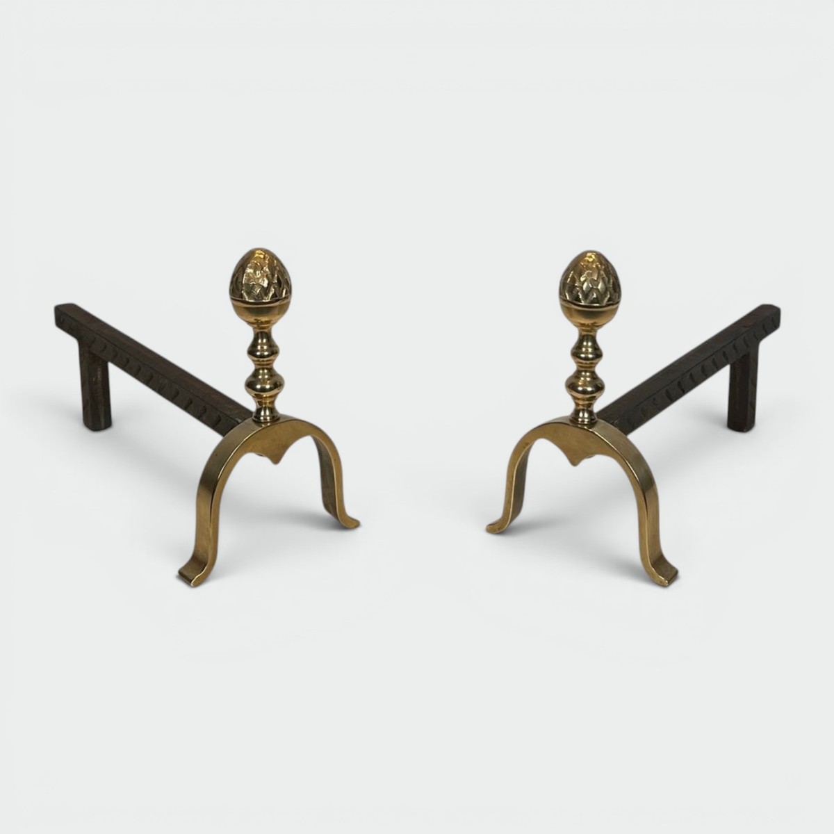 Pair Of Neoclassical Brass And Iron Andirons With Pine Cone Finials, In The Style Of Maison Jan