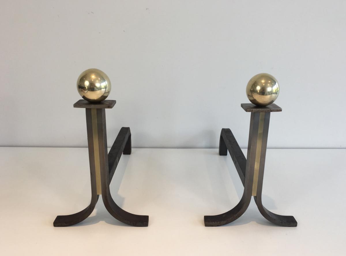 In The Style Of Jacques Adnet. Pair Of Modernist Steel, Iron And Brass Andirons. French. Circa 