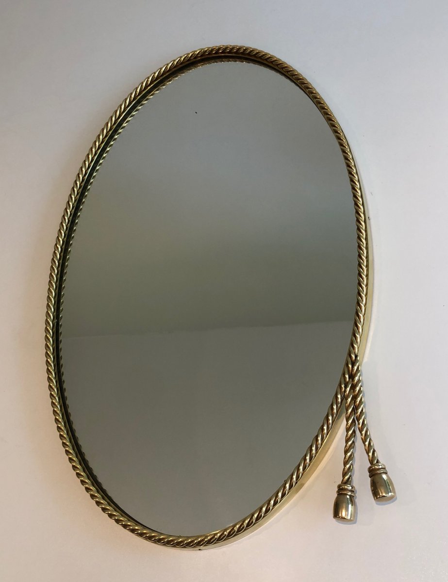 Dans Le Goût De La Maison Bagués. Miroir Oval En Laiton Entouré d'Une Cordelette Et De Pompons