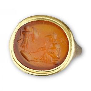 Gold Ring With A Roman Intaglio Of A Seated Minerva Before A Trophy Of Armour.