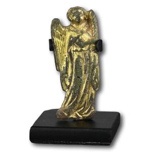 A Gilt Bronze Figure Of Candle Bearing Angel. Probably French, 14th Century.