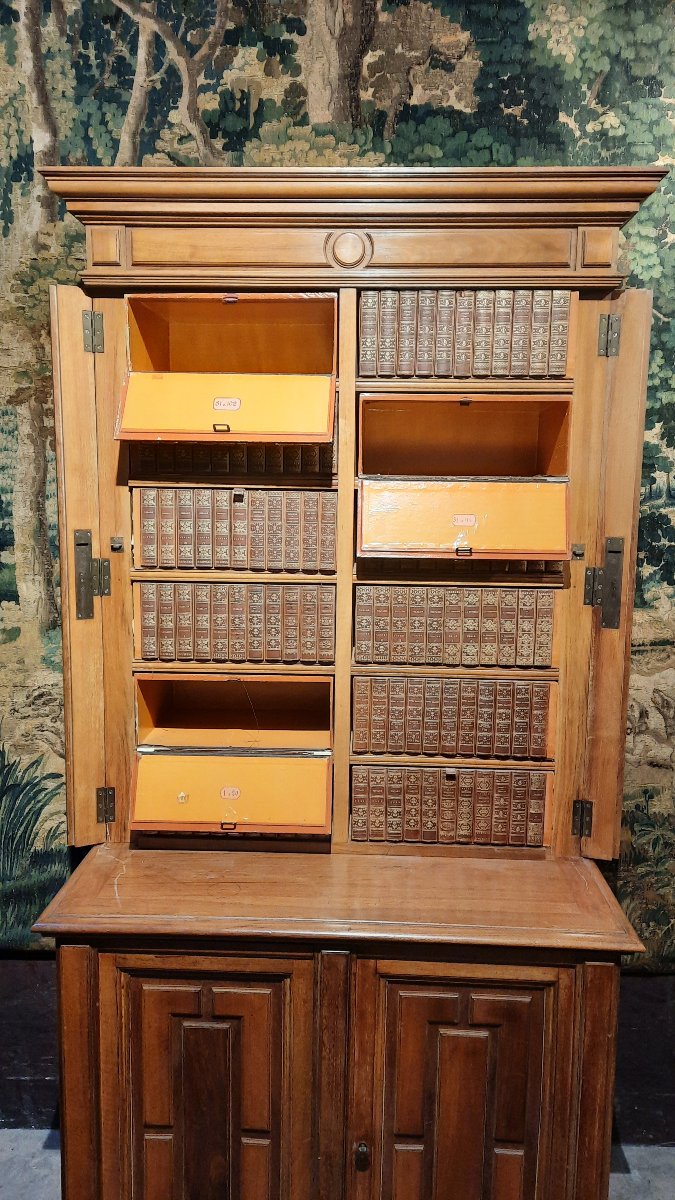 A Small Cabinet With Boxes Decorated With Books -photo-4