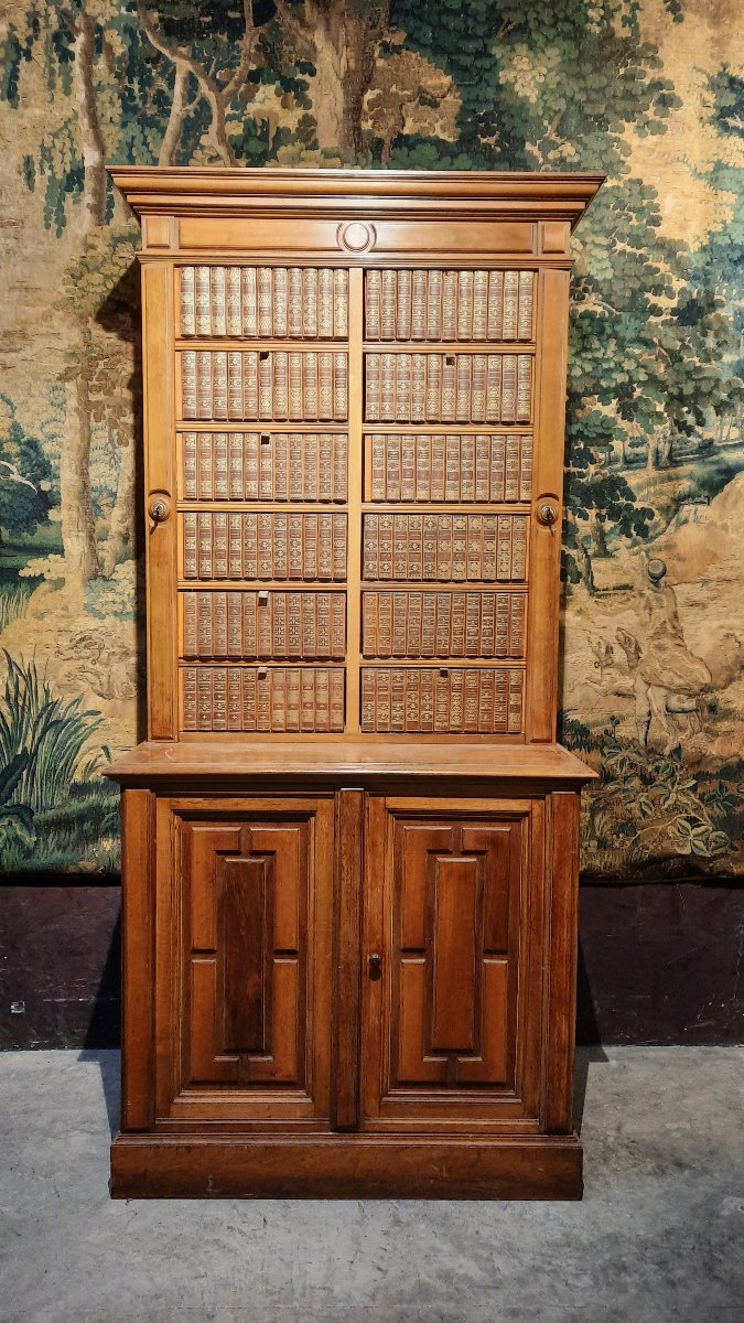 A Small Cabinet With Boxes Decorated With Books 