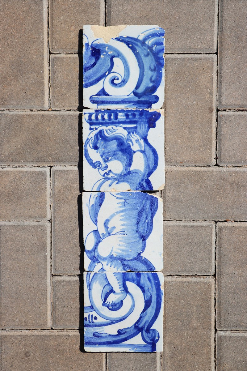 18th Century Set Of Four Tiles Depicting A Cherub Holding A Baroque Torchiere