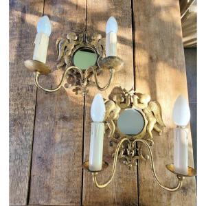 Pair Of Mirror Sconces With Trumpet Cherubs In Golden Iron.