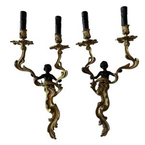 Large Pair Of Wall Sconces Known As The "angel" Sconces, In Chiseled, Gilded Bronze With A Black Patina
