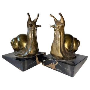 Suzanne BIZARD ( 1873-1963) Rare paire de serre-livres Art Déco en bronze doré. Signés