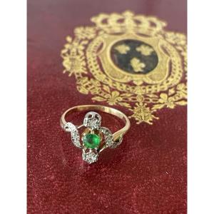 Rose Gold Ring With Diamonds And A Round Emerald