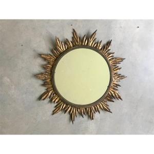 Miroir soleil à décor de feuilles dorées, vers 1950.