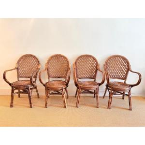 Suite de 4 chaises avec accoudoirs en rotin années 60.