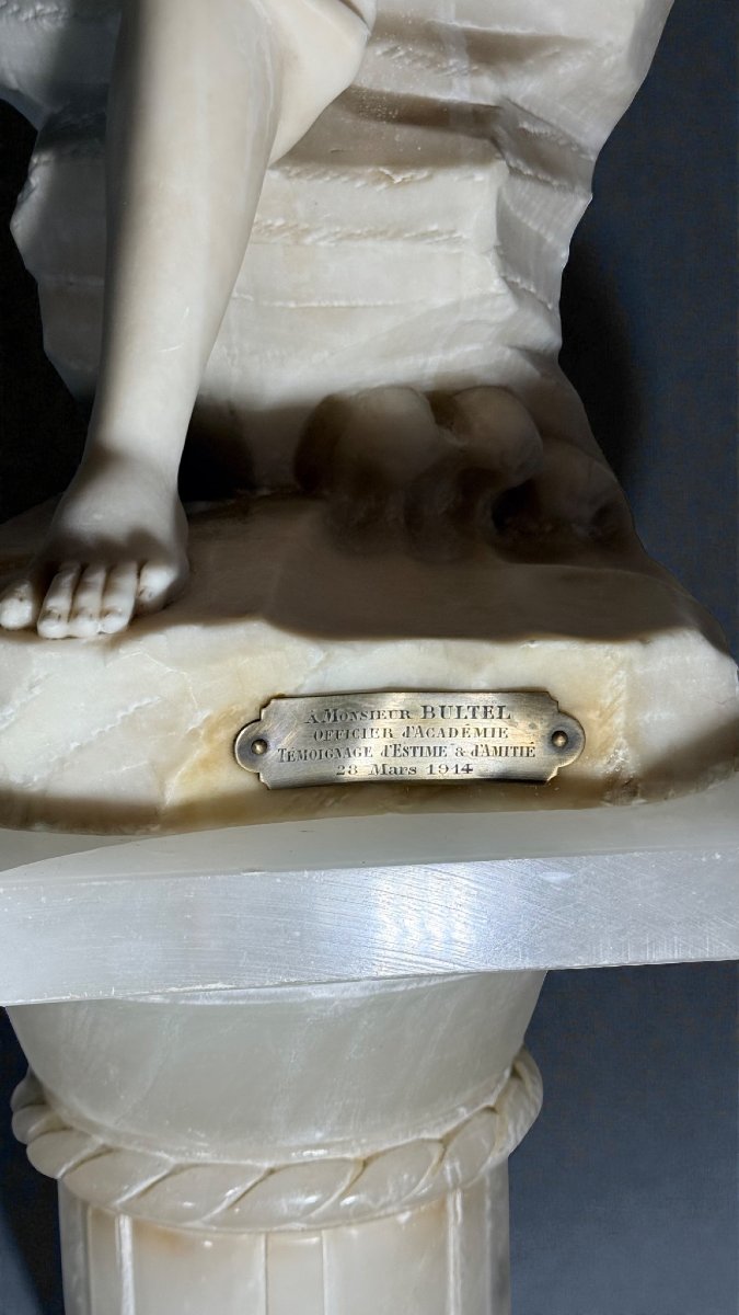 Statue Depicting A Smiling Girl With Column In Marble -photo-6