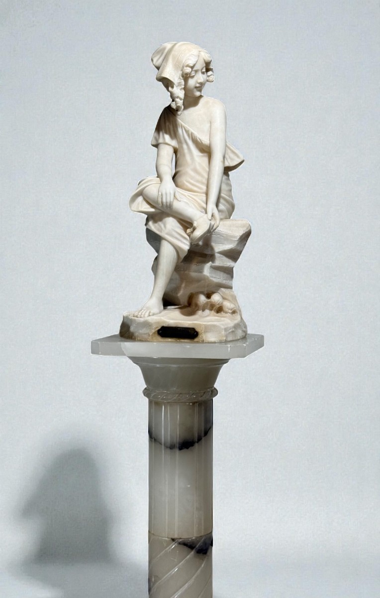 Statue Depicting A Smiling Girl With Column In Marble 