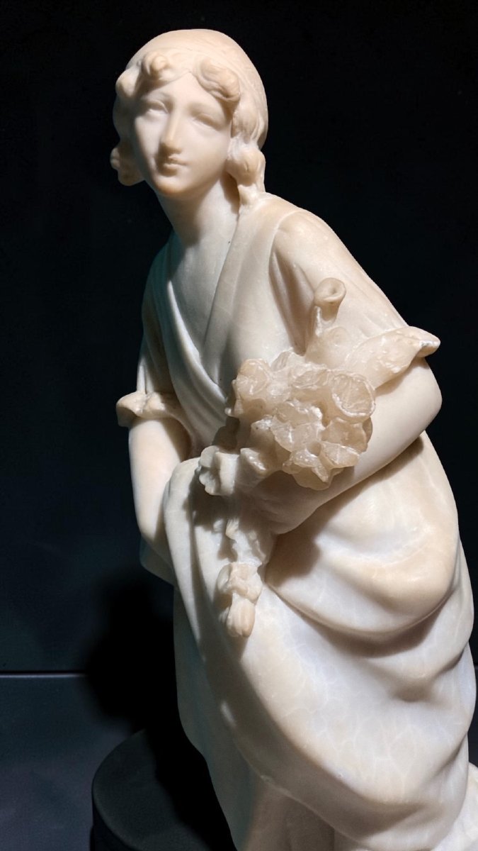 Statue Depicting A Little Girl With Flowers -photo-1