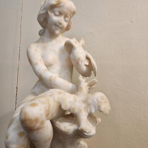 Statue Depicting A Girl Playing With Two Birds