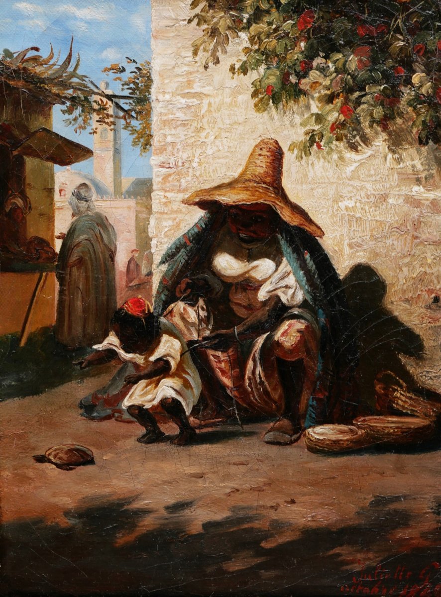 Juliette G. , Femme du Maroc et son enfant jouant avec une tortue
