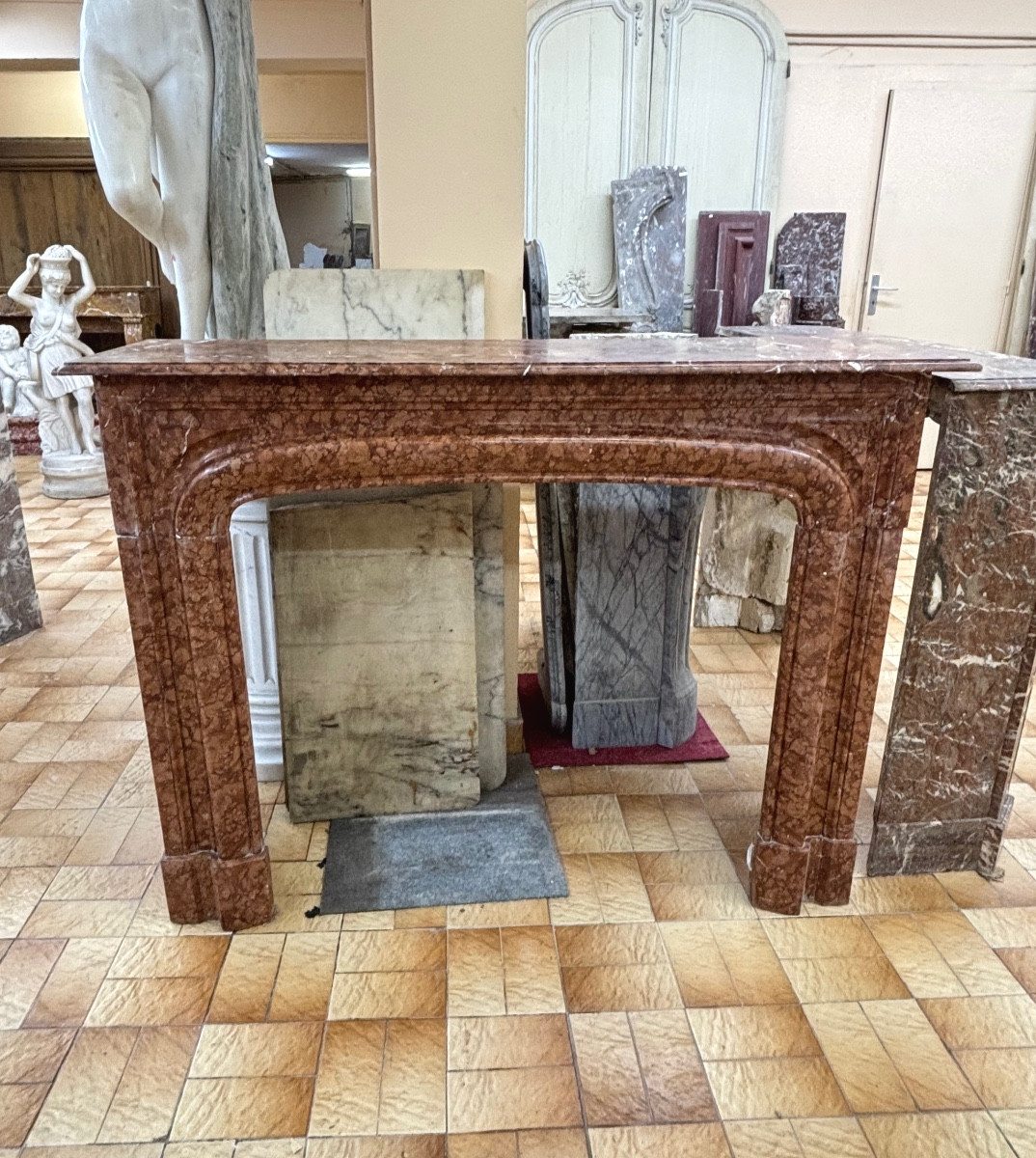 Antique Louis XIV Style Fireplace Known As Boudin Made Of Orange Marble From The Late 19th Century 