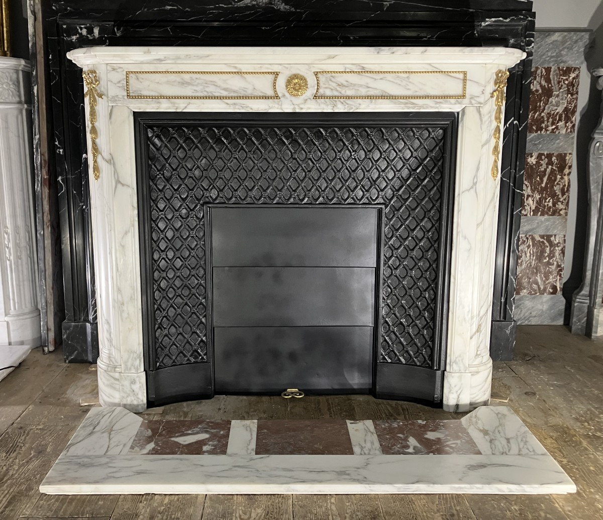 Antique Louis XVI Style Fireplace With Bronze Mounts In Calacatta Marble.