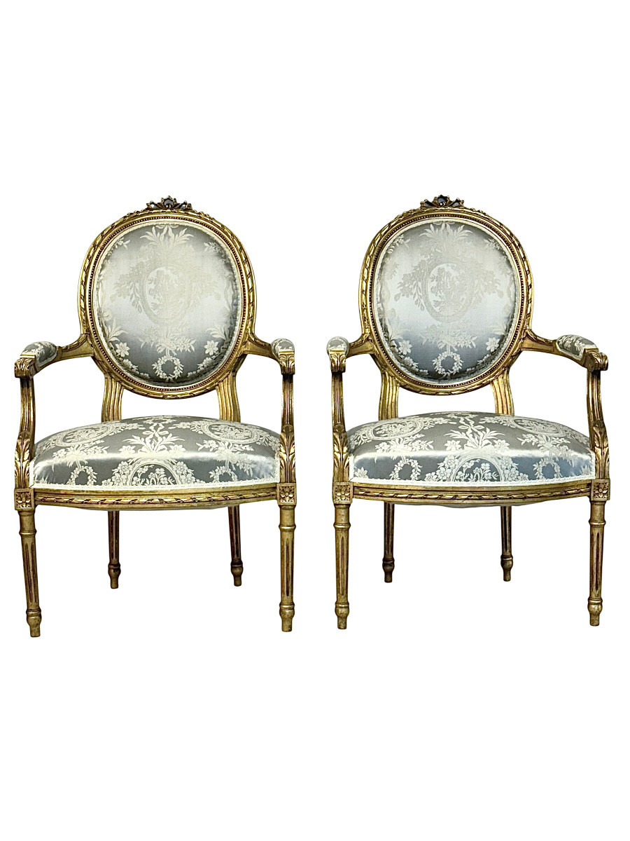Pair Of Louis XVI Medallion Carved And Gilded Wood Armchairs