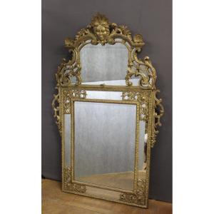 Miroir Régence à Parecloses en bois sculpté et doré XVIIIe 