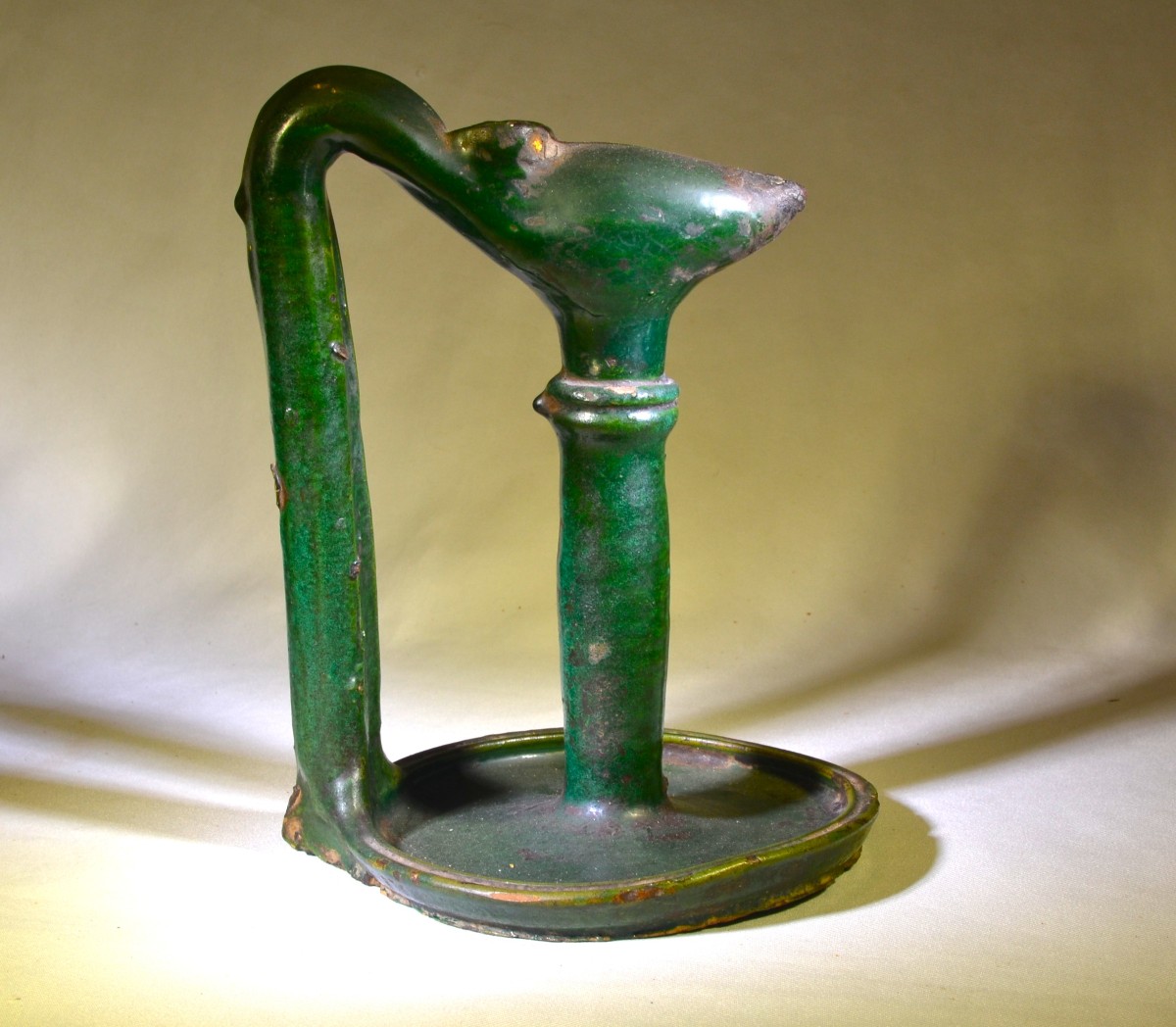 Green Glazed Earthenware Oil Lamp. Morocco, 19th Century.