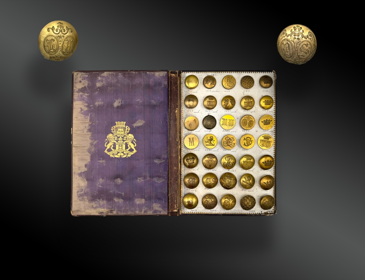 Coat-of-arms And Heraldic Buttons On A Display Book From Maison Gourdin & Co.  