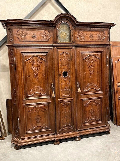 A Wardrobe With An 18th-century Clock