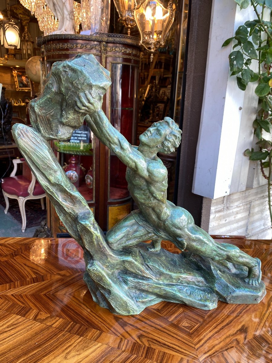 Art Deco Sculpture In Bronze With Green Patina, The Man With The Stone Signed Ouline