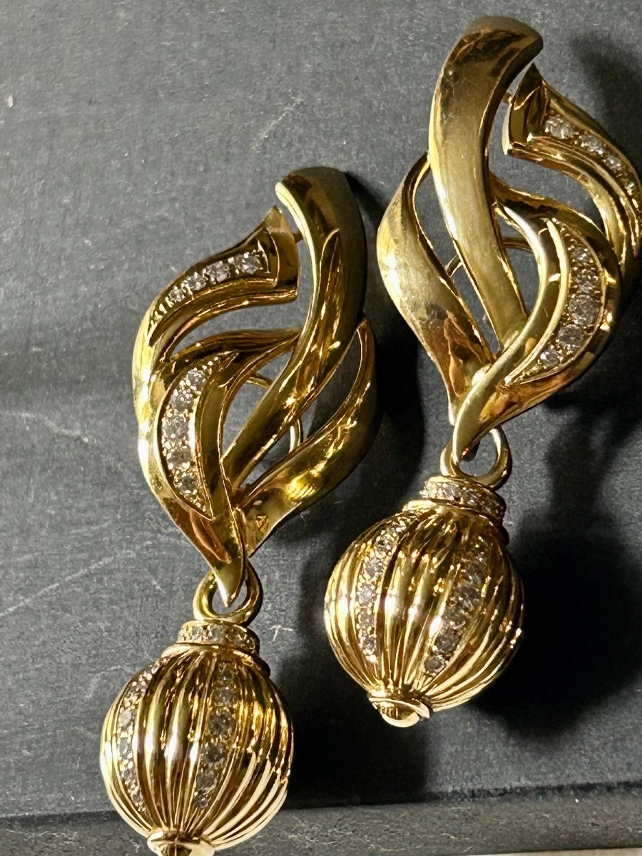 Pair Of Gold And Shiny Earrings-photo-1