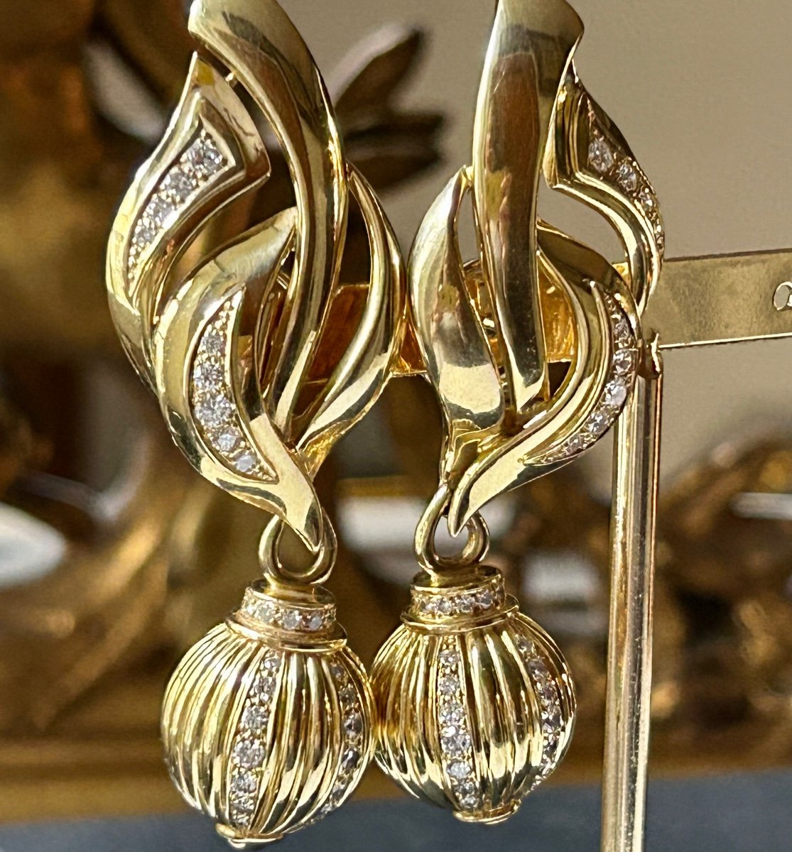 Pair Of Gold And Shiny Earrings-photo-3