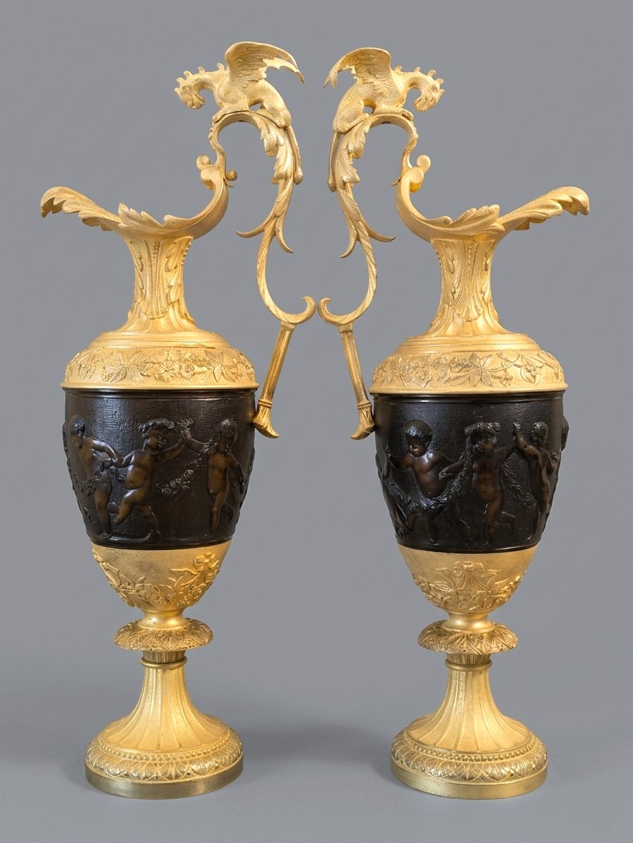 Pair Of Ewers In The Antique Style "bacchanal Of Putti And Dragons" Patinated And Gilded Bronze