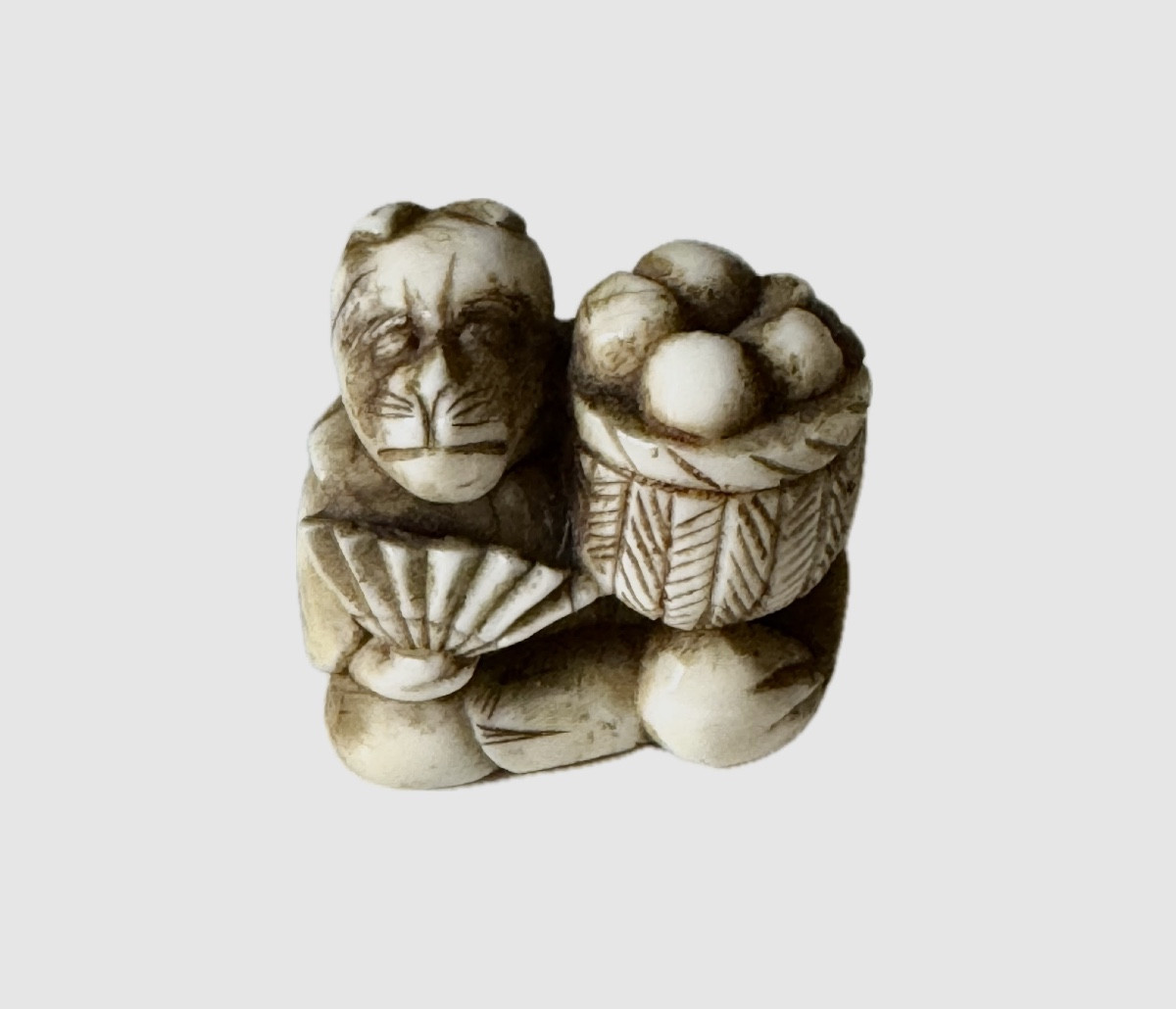 Netsuke Made Of Deer Antlers, Fruit Seller With Monkey Mask.