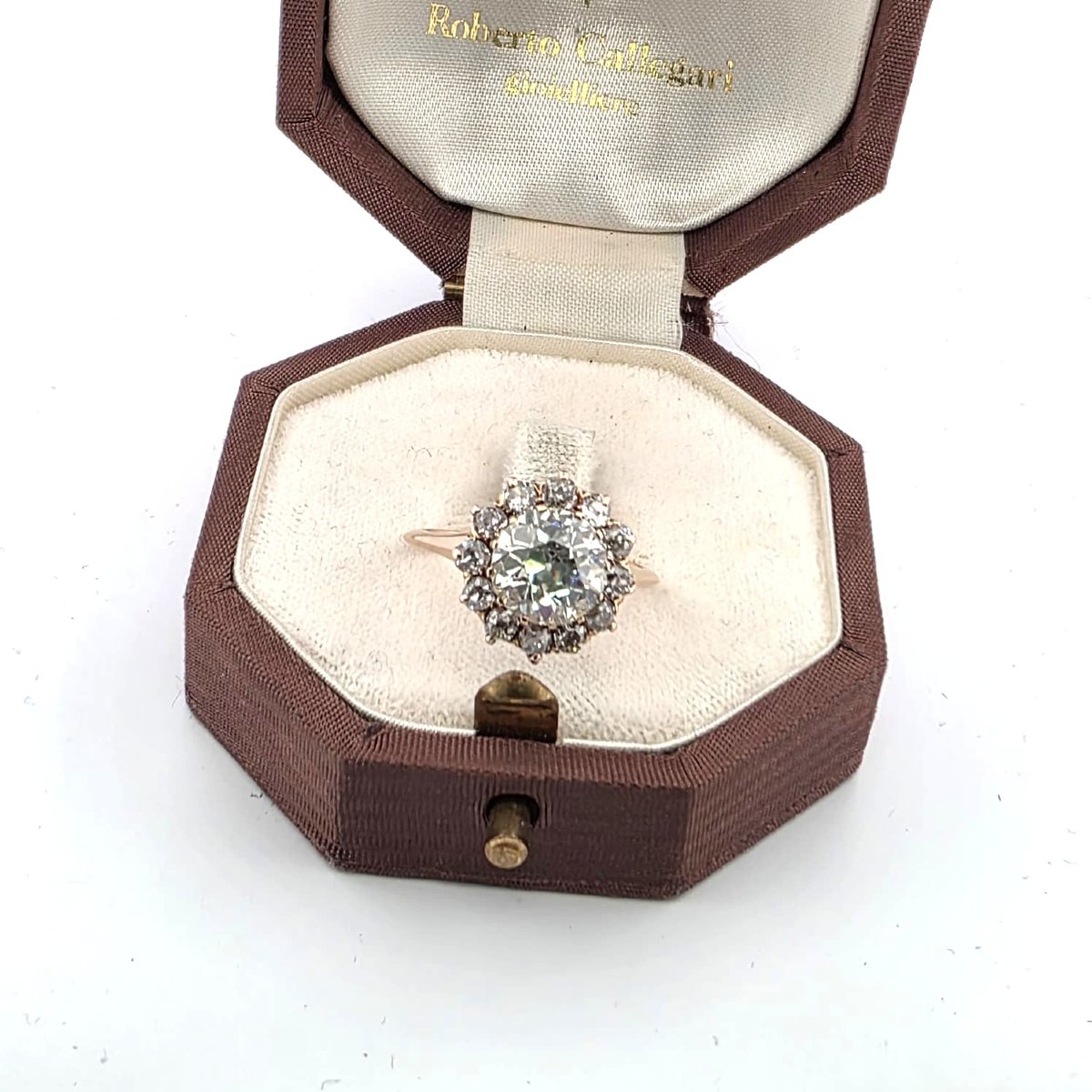 18kt Rose Gold Ring With A Center Diamond And Diamonds Set Around It