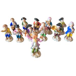A Superb Collection Of 12 Polychrome Porcelain Figurines Depicting The Famous S Orchestra