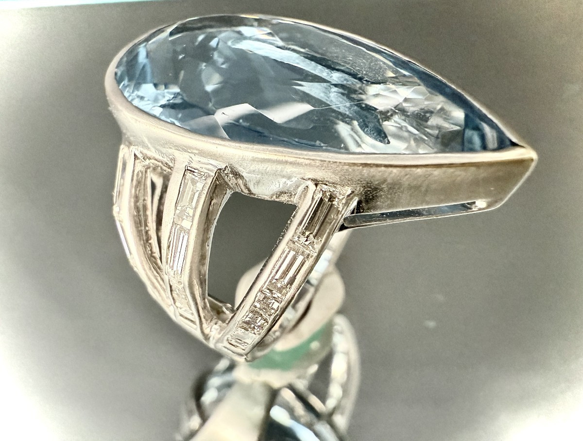 Bague en or blanc sertie d’une Topaze d’environ 30 carats et ornée de 26 diamants 