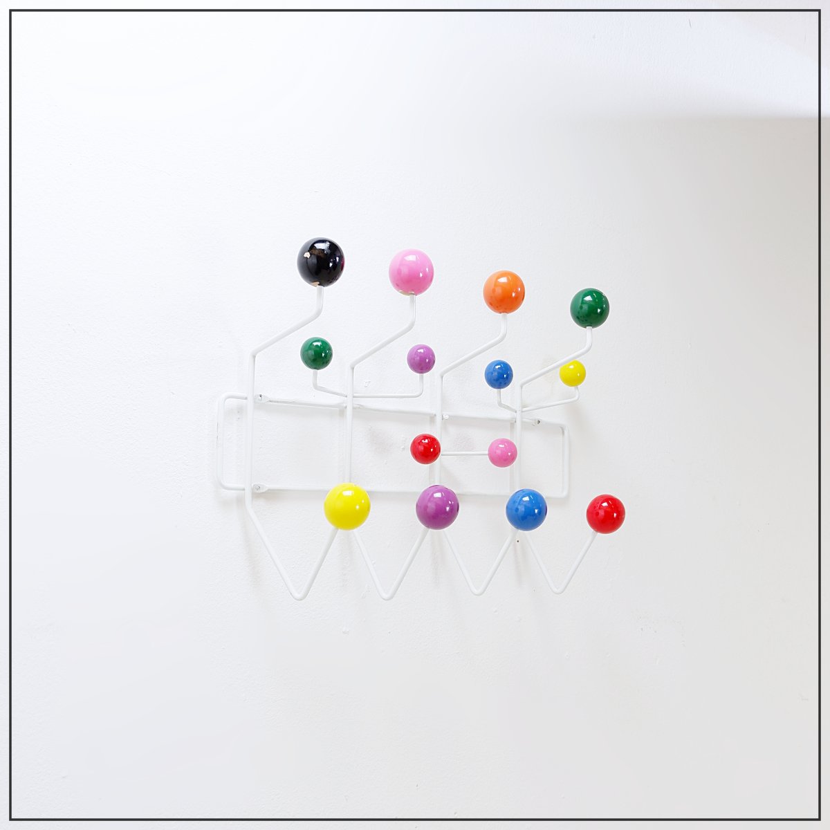 Porte-manteau mural avec boules colorées et structure métallique, style «Hang It All»